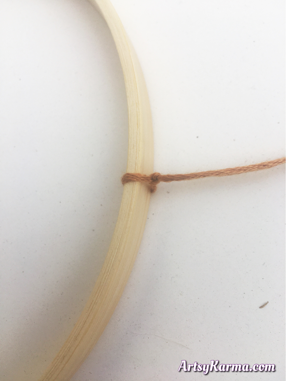 Tie string to your hoop to make a button mobile craft