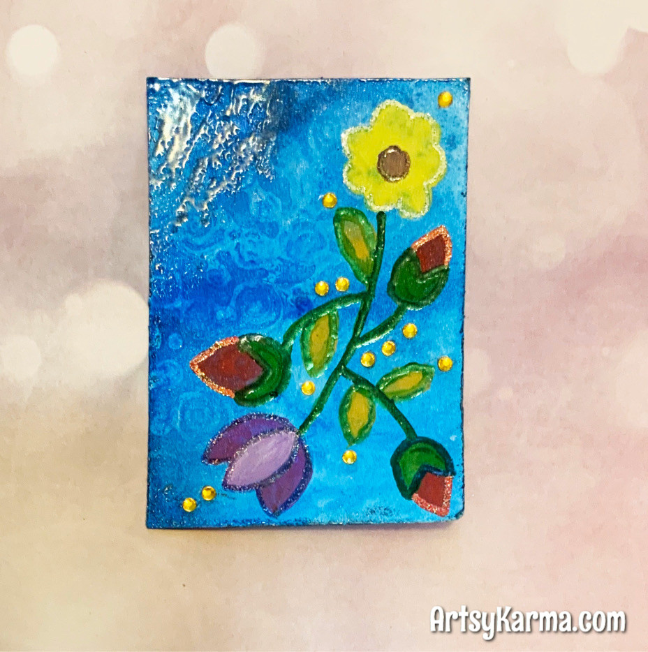 altered playing card with acrylic resist background