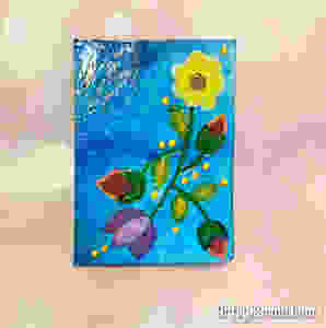altered playing card with acrylic resist background
