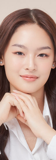Woman with long brown hair in white shirt