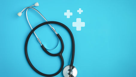 Black stethoscope on bright blue background with white medical cross icons, clean healthcare-themed image