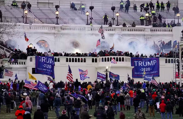 Violent protesters, loyal to Donald Trump, storm the U.S. Capitol on Jan. 6, 2021. (AP Photo/John Minchillo)