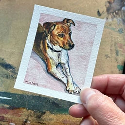 a miniature watercolour pet portrait of a jack russell terrier being held by thumb and finger
