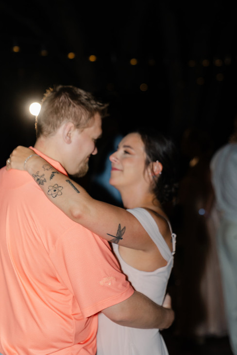 The bride and groom sharing an intimate embrace and smile on the dance floor during their Zion National Park wedding reception.