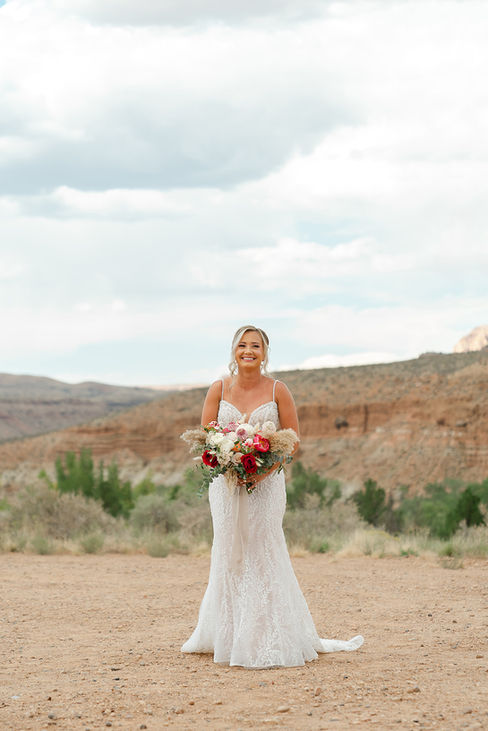 The bride walking toward the stone labyrinth ceremony site at a Zion National Park wedding.