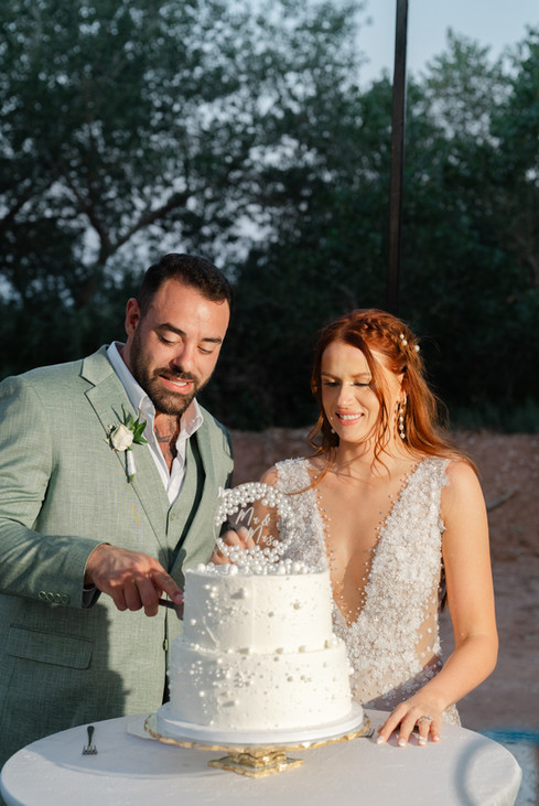 The newlyweds, Laurel and Thomas, smiling as they prepare to cut their wedding cake during their Zion National Park Wedding reception.