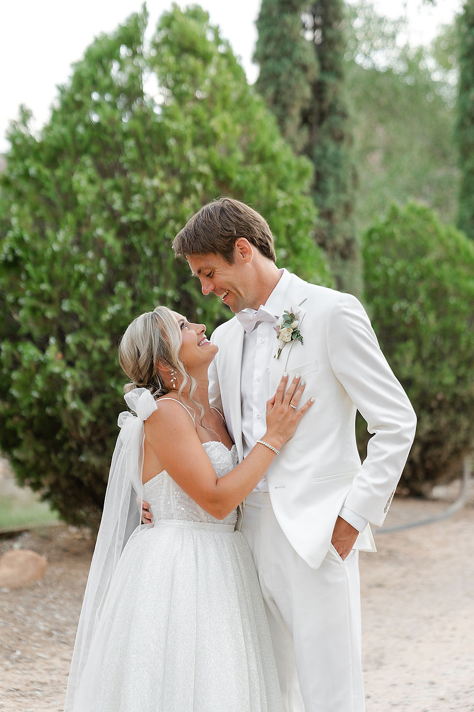 An intimate close-up of the bride and groom embracing and smiling together during their Zion National Park wedding.