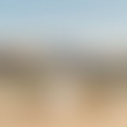 Adventure wedding bride and groom posing on a rocky ridge with the iconic red rock peaks of Zion National Park in the background.