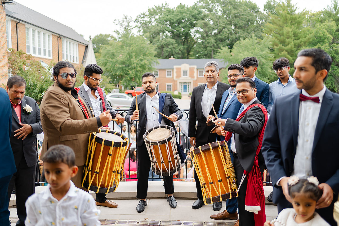 Traditional Indian drummers performing outside Our Lady of the Pillar church in St. Louis to celebrate Sarah and Vince’s multicultural wedding, planned by Big Bow Events.