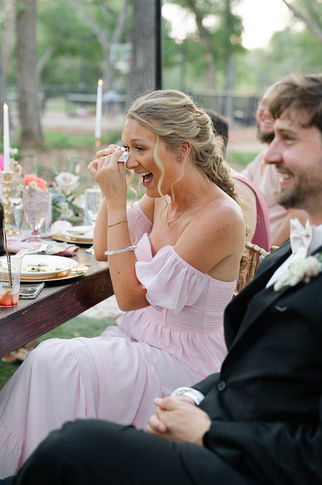 An emotional guest wiping away tears during a moving speech at a Zion National Park wedding reception.