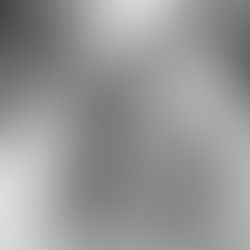 A bride and groom sharing a first kiss at their Zion National Park wedding ceremony, featuring a lush floral arch and dramatic red rock canyon views in the background.