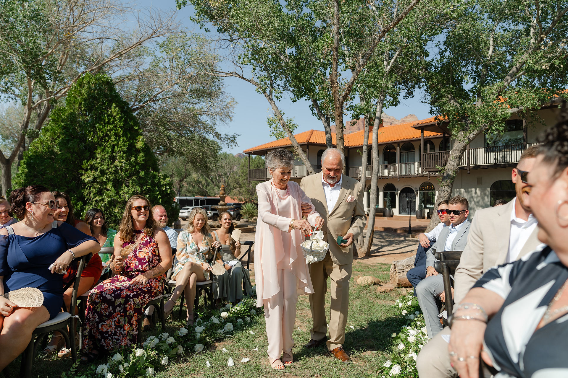 A heartwarming moment of the groom's grandmother serving as the flower girl during the outdoor Zion National Park Wedding ceremony.
