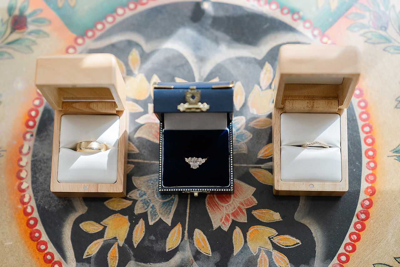 A delicate floral ring accessory placed on a traditional South Asian wedding garment for a Big Bow Events production.