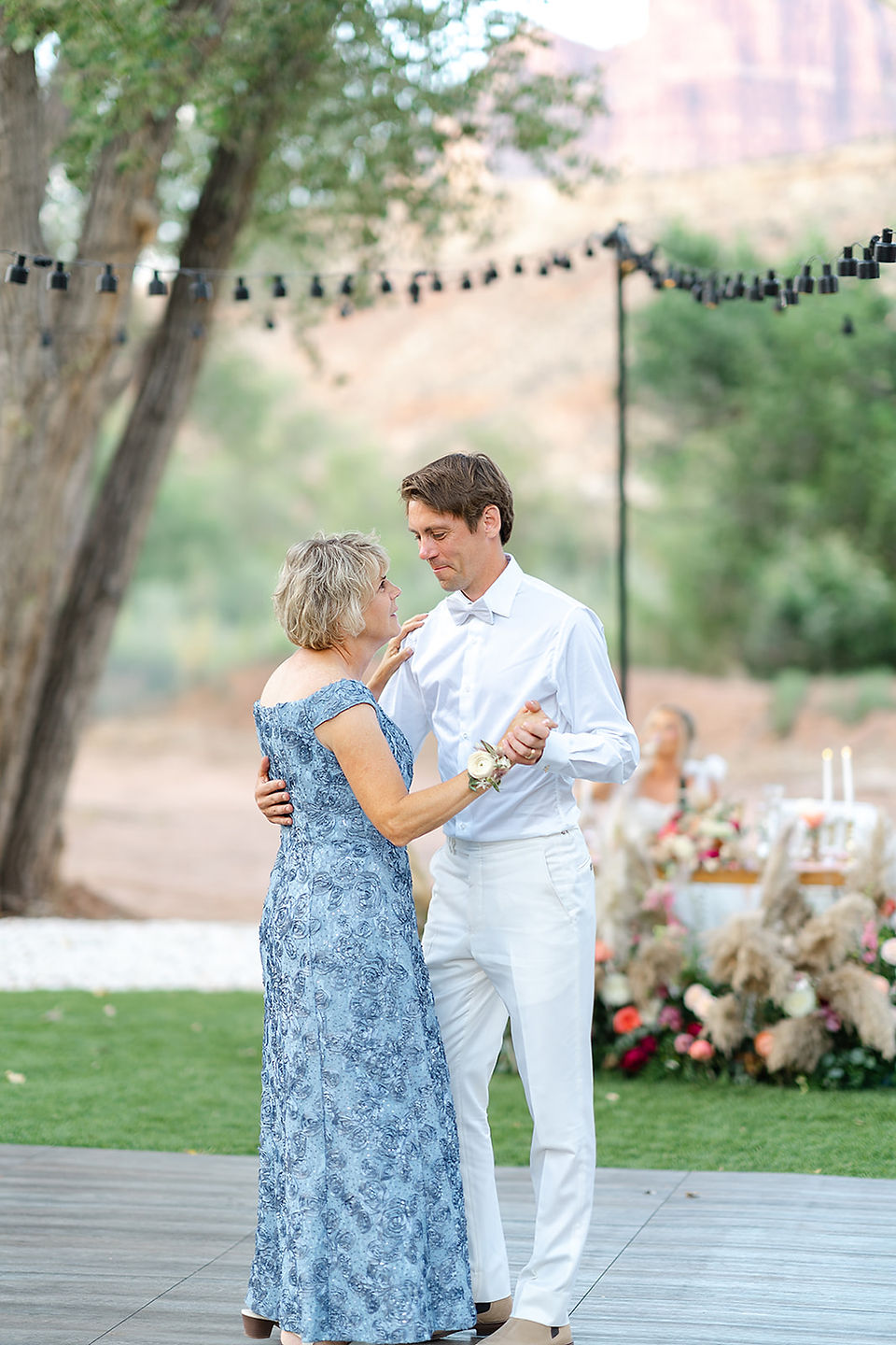 The groom and his mother sharing an emotional dance at an outdoor Zion National Park wedding.