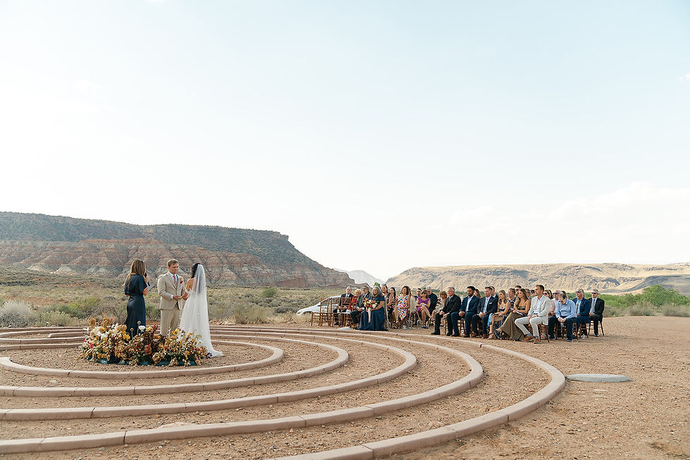Olivia & Bradley sharing a moment with their favorite people in a desert landscape inside a labyryth.