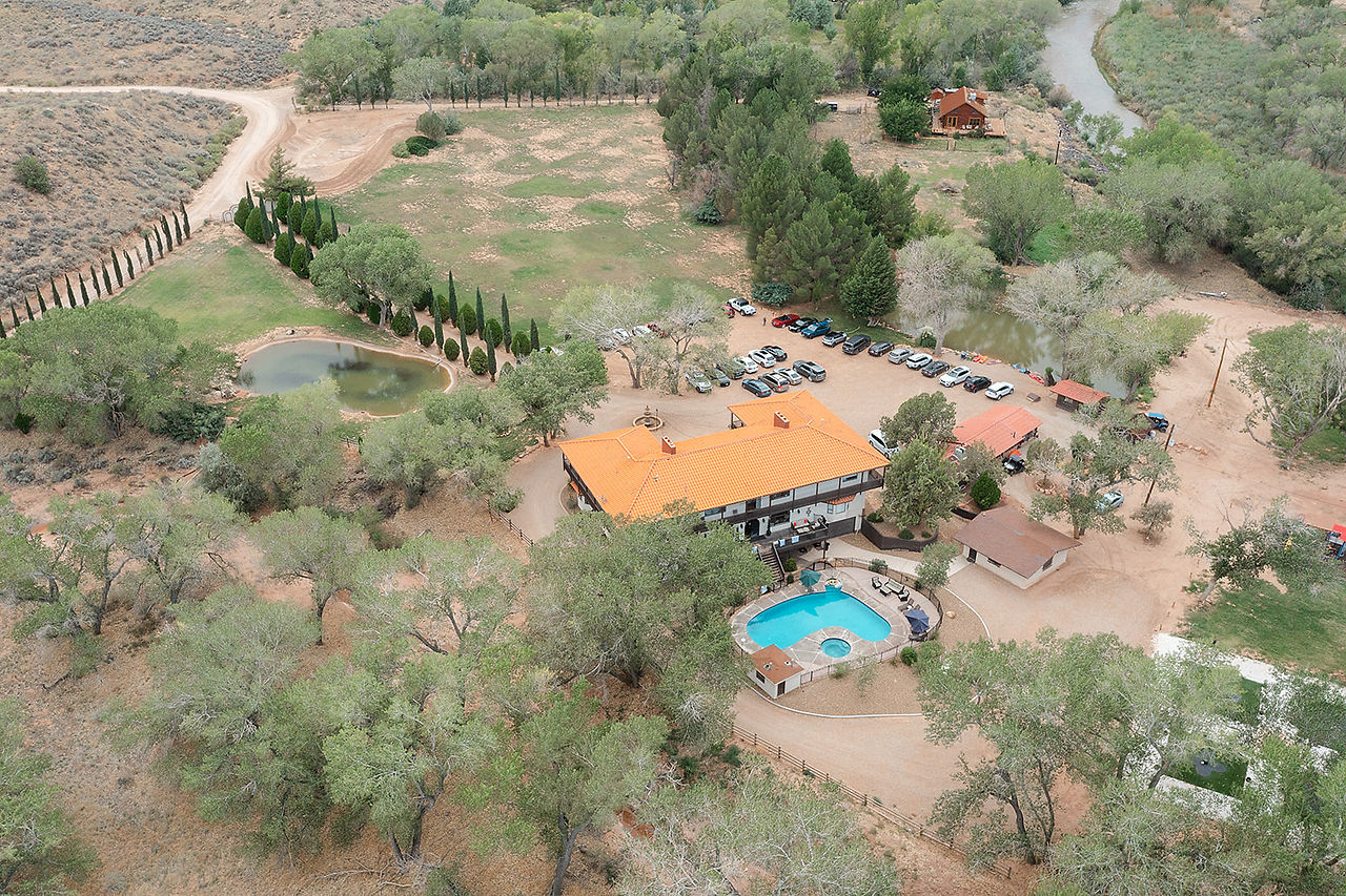 A wide-angle aerial shot of the luxury villa and outdoor pool area at a Zion National Park wedding venue.