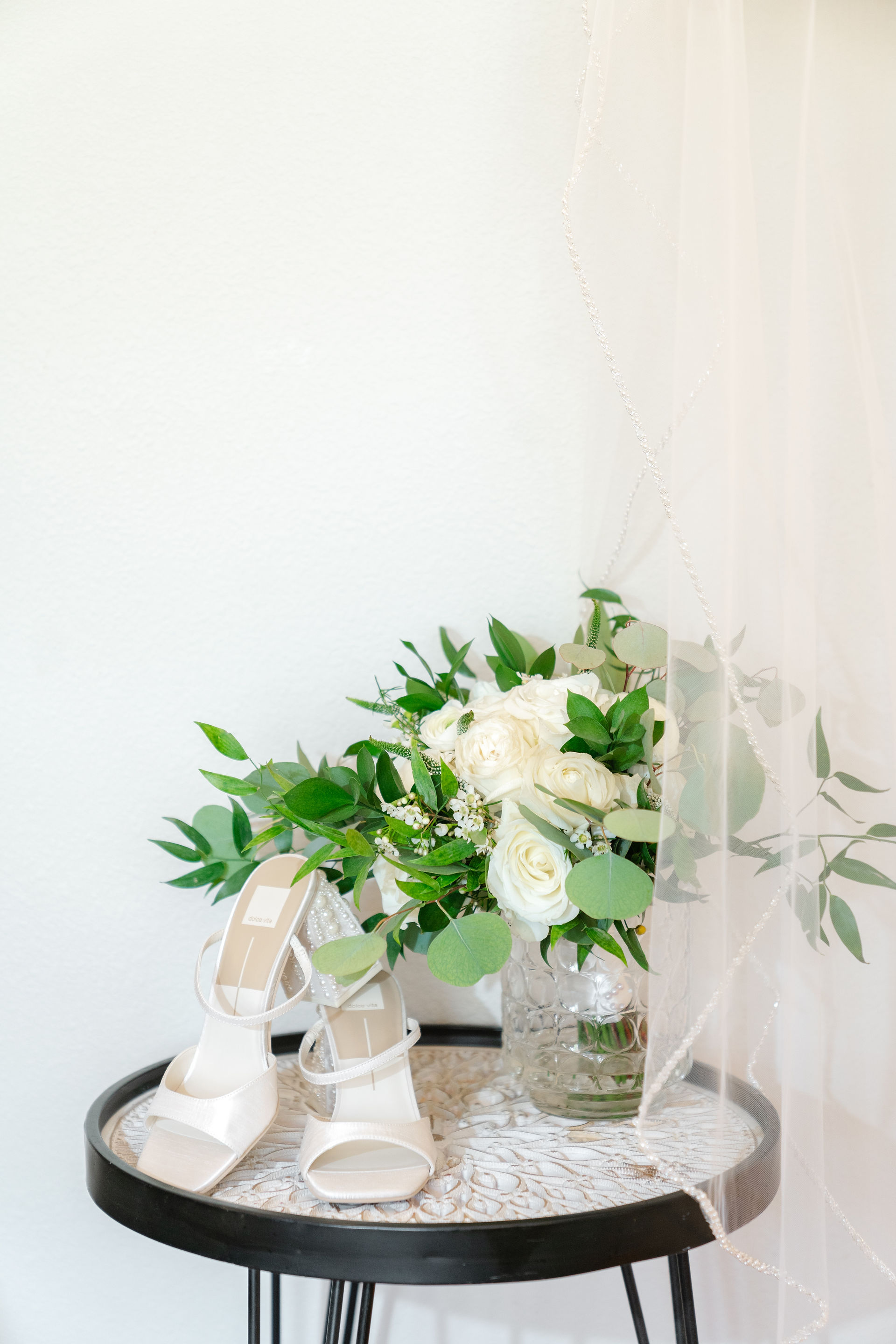 A lush white floral bridal bouquet paired with ivory wedding shoes at a stunning Zion National Park Wedding venue.