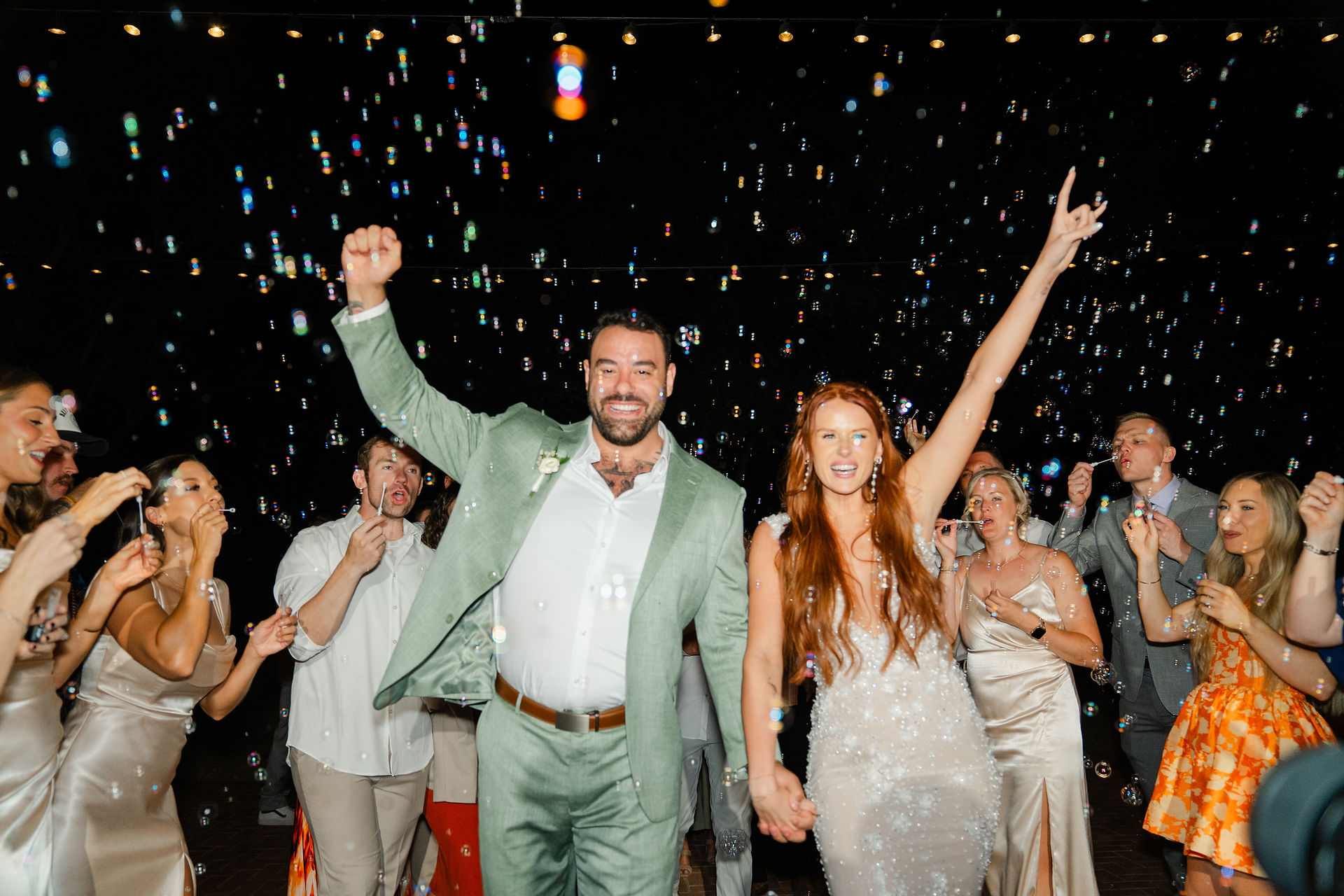 A high-energy candid of the newlyweds and their guests cheering with their arms raised during a lively Zion National Park Wedding reception.
