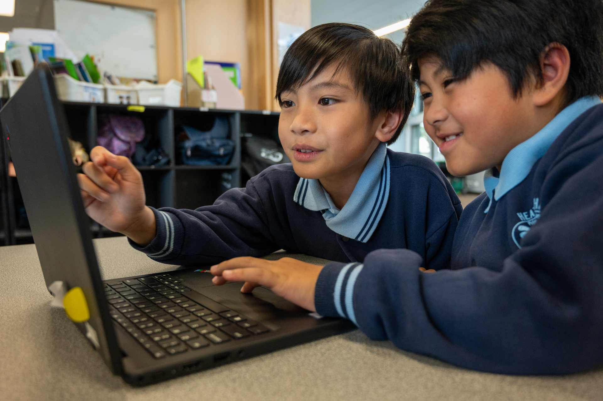 Two students on laptop