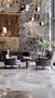 Luxurious lobby of building with two charis and hanging lights.