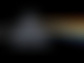 A prism on a black background refracts white light into a rainbow spectrum, displaying vivid colors like red, orange, yellow, green, blue, and purple.