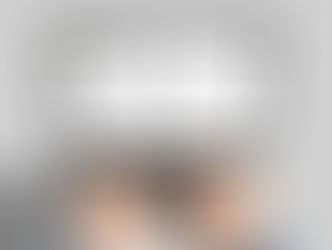 Hands typing on a laptop displaying an email titled "Question Regarding Assignment" from a college professor. Gray background.