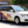 An image of a Dodge Town and Country van branded with A&L Transportation on the side, tran