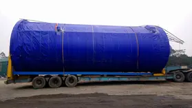 Hàng dự án (Project Cargo) - bồn chứa quá khổ được bọc bạt bảo vệ, chằng buộc trên rơ moóc sàn thấp trước khi vận chuyển
