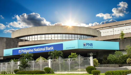 PNB Financial Center office building in Manila Bay Area, Pasay City, modern Grade A commercial office space with Grand Atrium, rooftop deck, EV charging stations, 24/7 access, located beside Concept Mall along a busy highway, ideal for corporate headquarters, professional services, and flexible office leasing