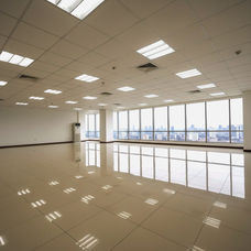 Finished office space for lease at The Exchange Square, Ortigas Center, Pasig City, featuring a spacious corporate floor with ceramic tile flooring, acoustic ceiling with LED lighting fixtures, painted walls, and split-type floor-mounted air-conditioning units. Ideal for BPO companies, corporate headquarters, or professional offices, move-in ready, bright, and modern office environment with excellent accessibility to Ortigas Avenue, SM Megamall, and The Podium.