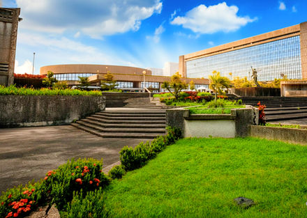 PNB Financial Center office building in Manila Bay Area, Pasay City, modern Grade A commercial office space with Grand Atrium, rooftop deck, EV charging stations, 24/7 access, located beside Concept Mall along a busy highway, ideal for corporate headquarters, professional services, and flexible office leasing