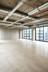 Bare shell office unit in McKinley Exchange Corporate Center 2, under construction, featuring an open layout, high ceilings, large floor-to-ceiling windows, and flexible office space ideal for BPOs, corporate offices, and professional workspaces in Makati City’s prime business district.