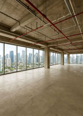 Spacious bare shell office floor in Altaire, Makati CBD, featuring open-plan layout, high ceilings, exposed structural columns, polished concrete flooring, and floor-to-ceiling windows with panoramic city views. Ideal for corporate offices, BPO setups, or flexible commercial workspace.
