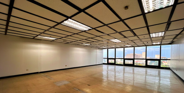 PNB Financial Center office building in Manila Bay Area, Pasay City, modern Grade A commercial office space with Grand Atrium, rooftop deck, EV charging stations, 24/7 access, located beside Concept Mall along a busy highway, ideal for corporate headquarters, professional services, and flexible office leasing