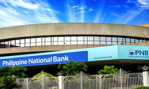 PNB Financial Center office building in Manila Bay Area, Pasay City, modern Grade A commercial office space with Grand Atrium, rooftop deck, EV charging stations, 24/7 access, located beside Concept Mall along a busy highway, ideal for corporate headquarters, professional services, and flexible office leasing