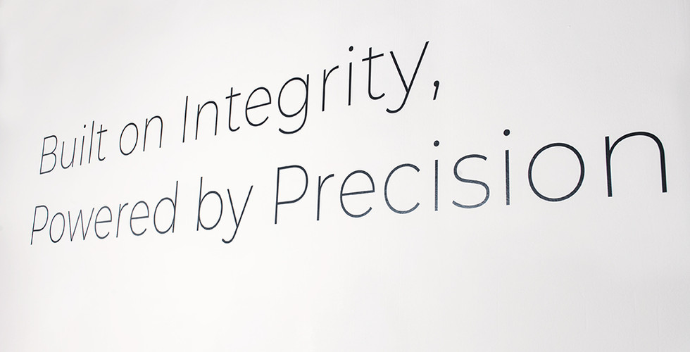 Wording built on integrity, powered by precision on white background