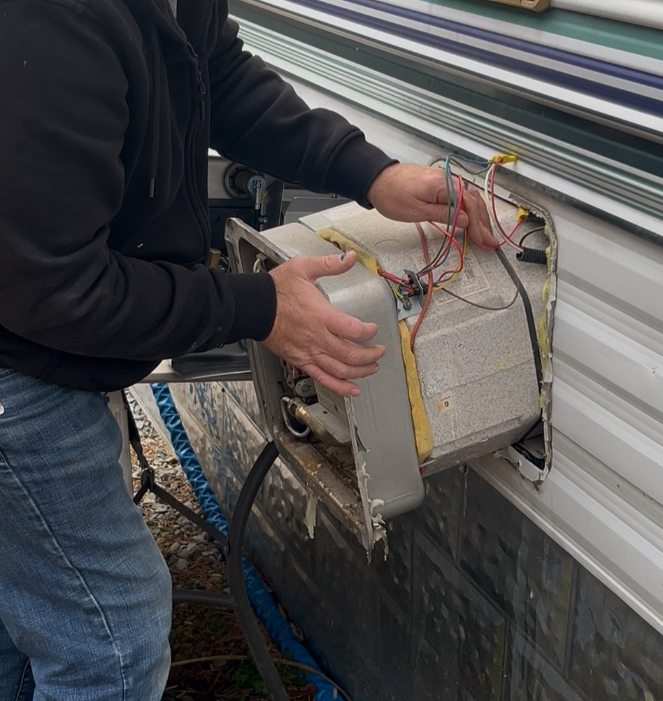 In this imge, we see RV tech, Jay Nelson removig an old water heater for a customer in Cosby,TN
