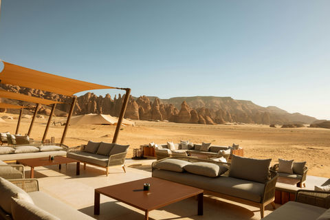 Luxury desert camp lounge with sandstone mountains in the background