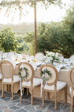 Wedding table setup olive trees lights in Greece