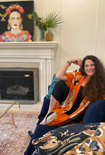 A photo of Jamie Cromer Grue sitting in a chair, smiling