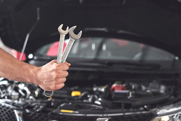 mechanic-holding-pair-wrenches-repair-garage.jpg