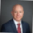Image of Paul Banz, Kalogon VP Sales, a man wearing a blue suit with white shirt and red tie