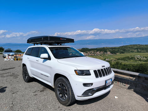 white jeep with a rooftop tent