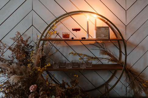 Neutral wildflowers decorate a white wall for a wedding