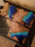 Mixed media art with cork and blue resin on wooden boards