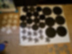 Collection of black circular and tree-shaped art cutouts.