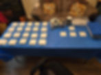 Art supplies and square white tiles on a blue table