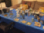Artist's workspace with paints and stamps on a blue table