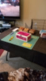Small pink and white wooden box on a green cutting mat