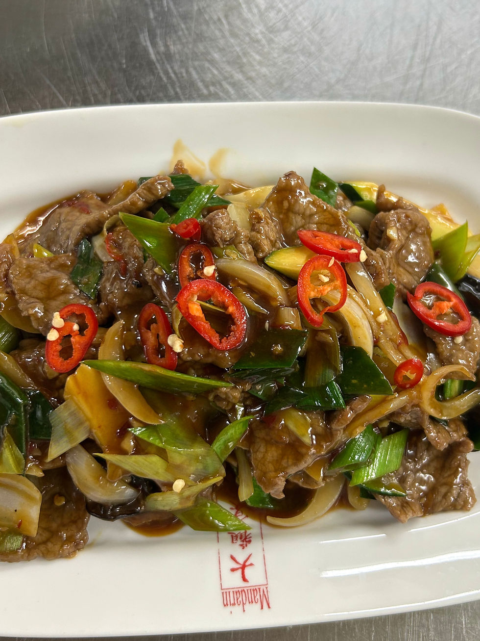 Close-up view of a traditional Chinese dish with vibrant colors and fresh ingredients